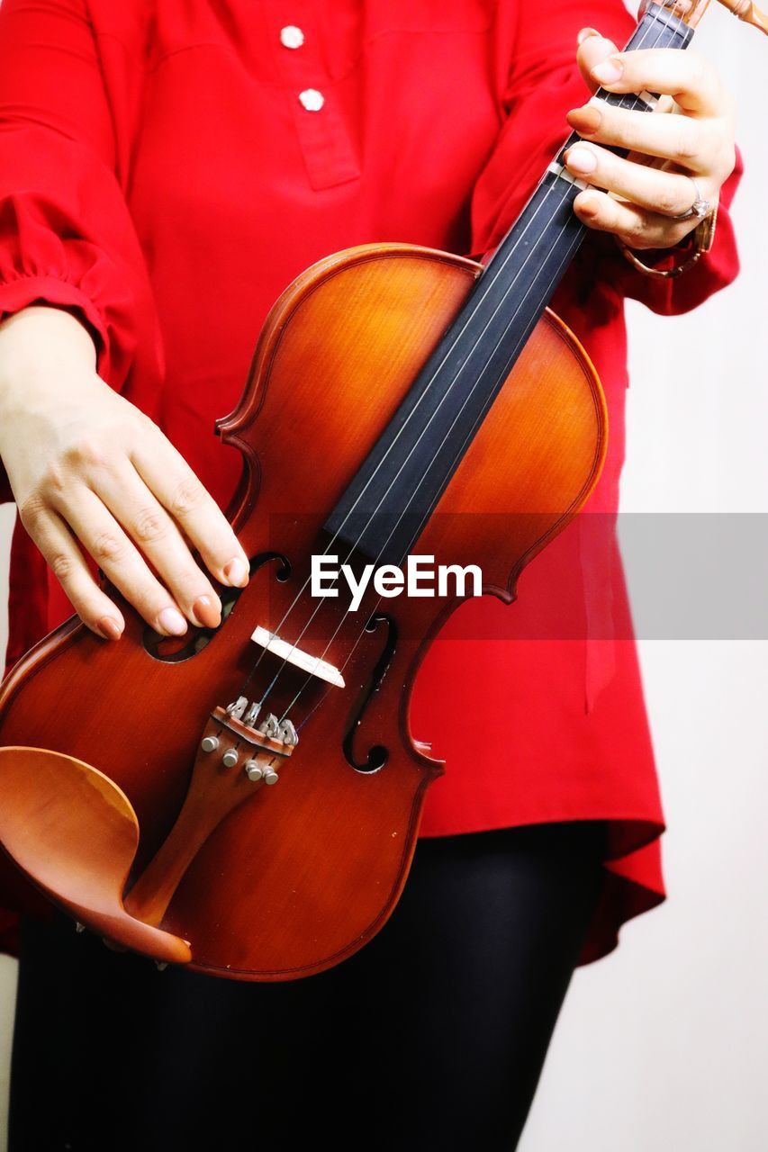 Midsection of woman playing violin