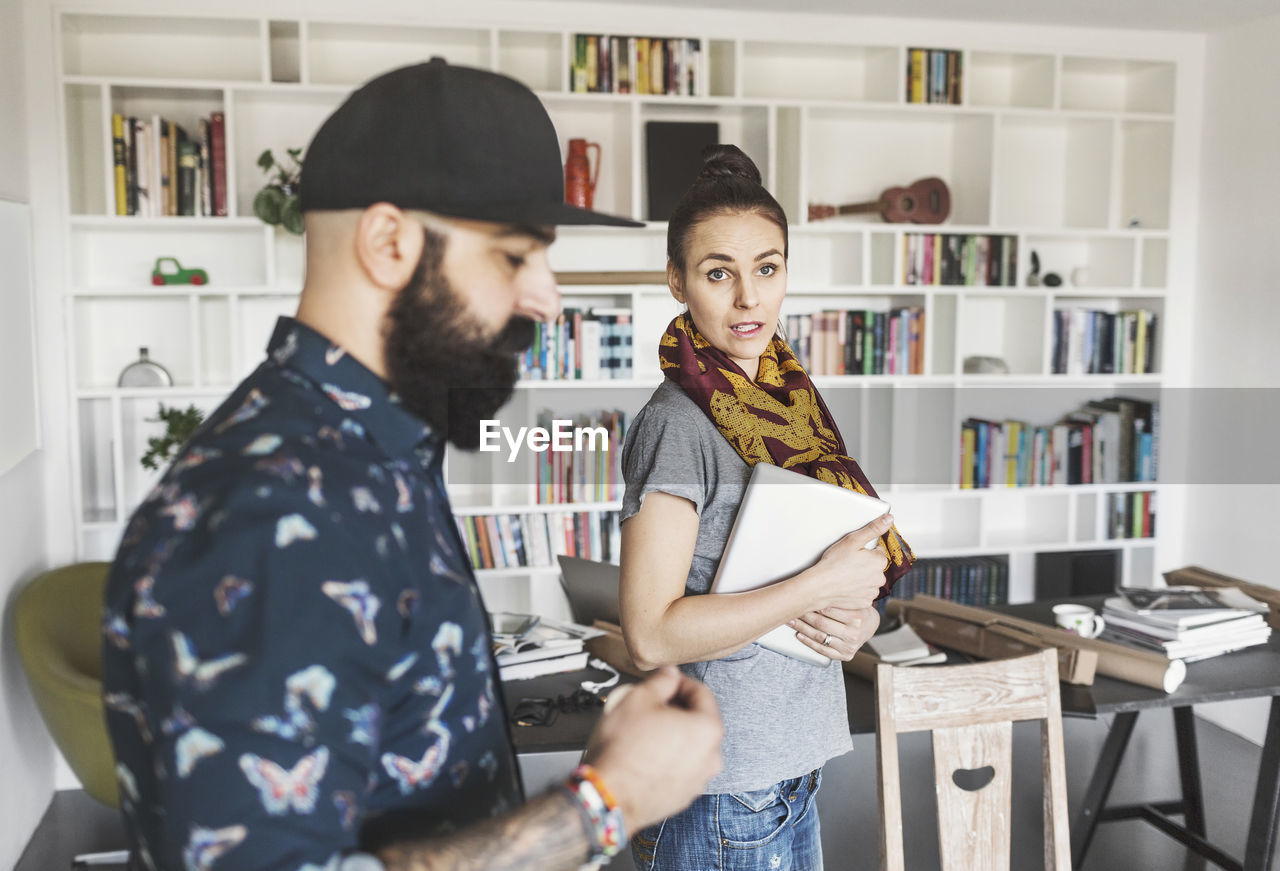 Male and female architects discussing in home office