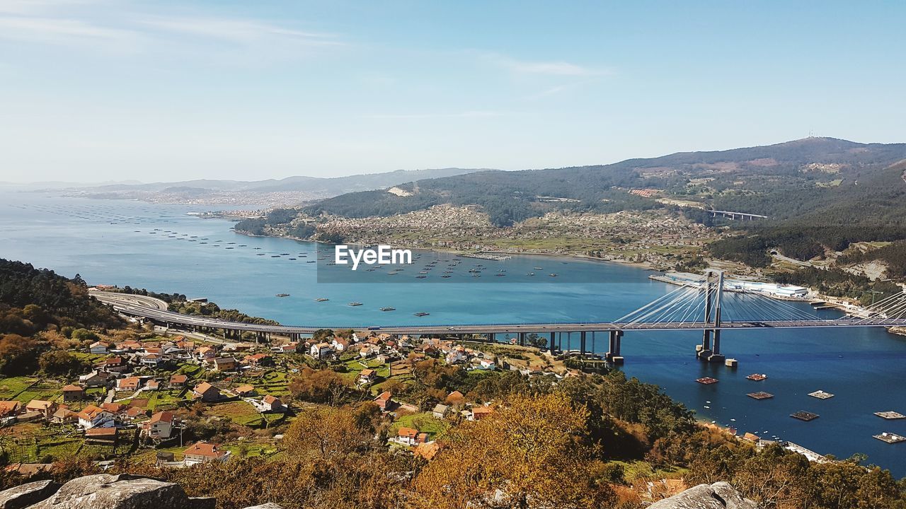 High angle view of sea and town against sky