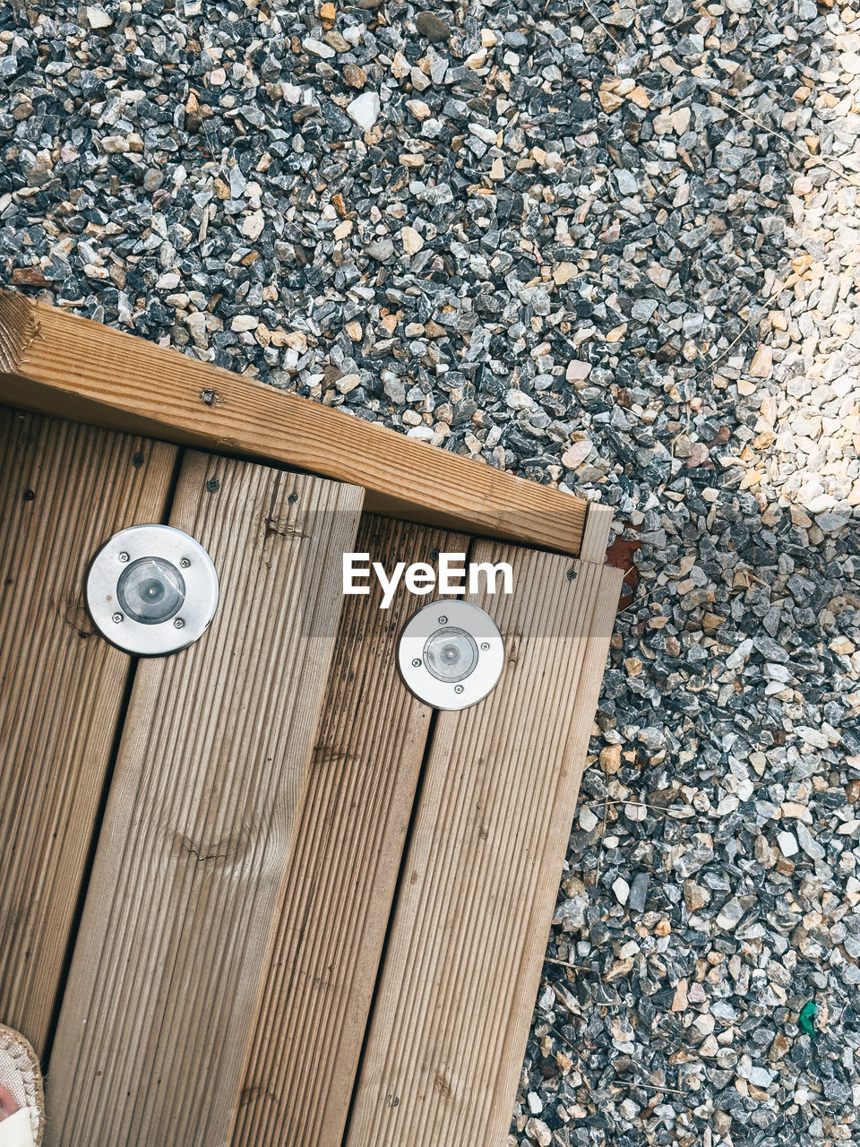 high angle view, flooring, day, wood, no people, floor, nature, outdoors, pattern, street, pebble, wall, sunlight, city, road surface, metal, footpath, stone