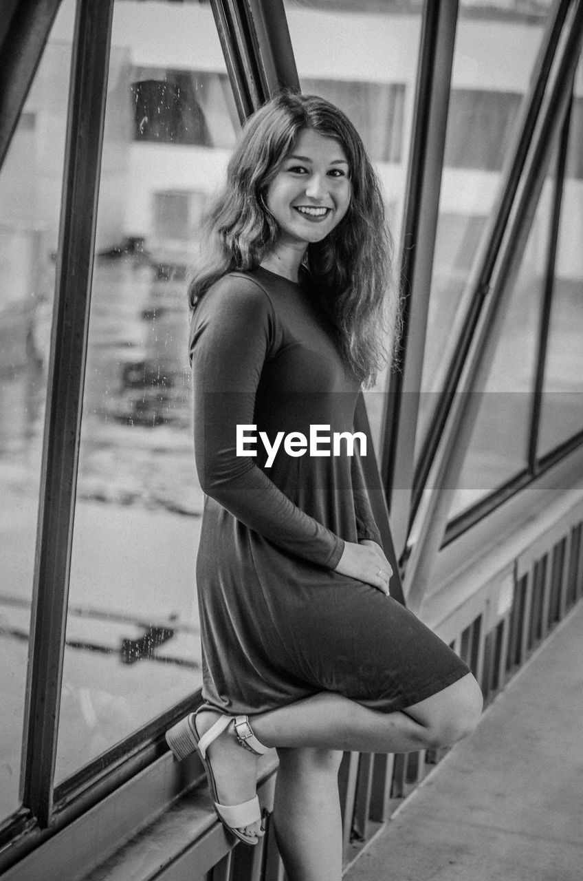 Portrait of beautiful girl standing on footbridge 