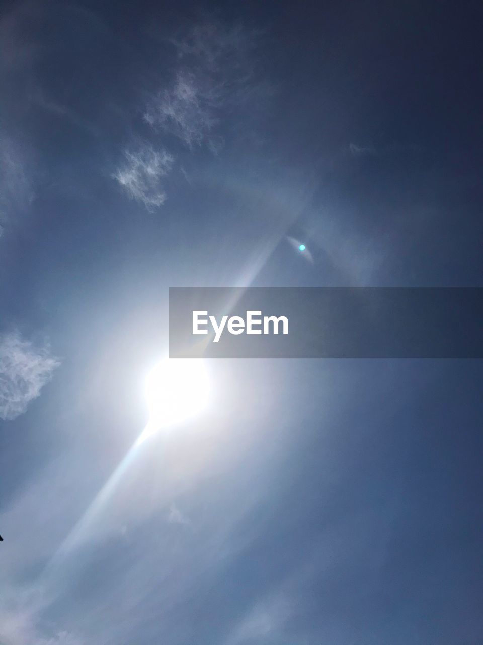 LOW ANGLE VIEW OF ILLUMINATED BRIGHT SUN IN SKY