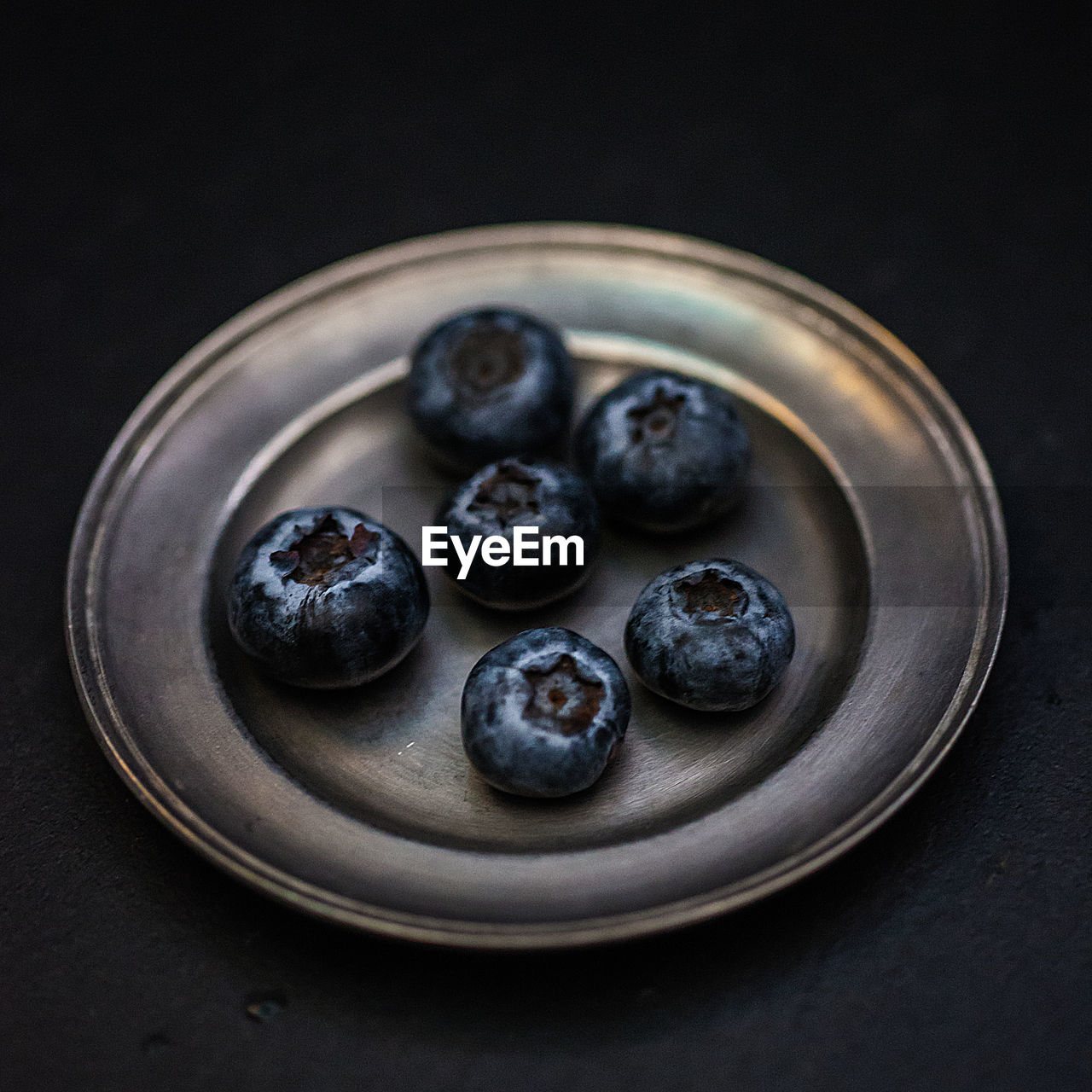 Close-up of blueberries in plate on table