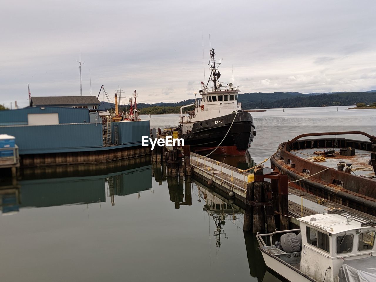 FISHING BOATS MOORED AT HARBOR