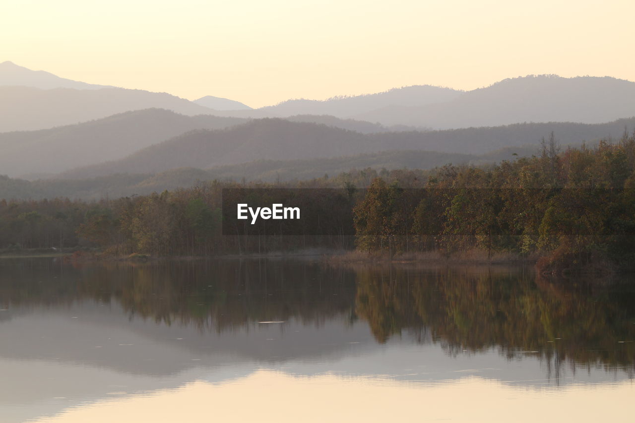 scenic view of lake and mountains against clear sky