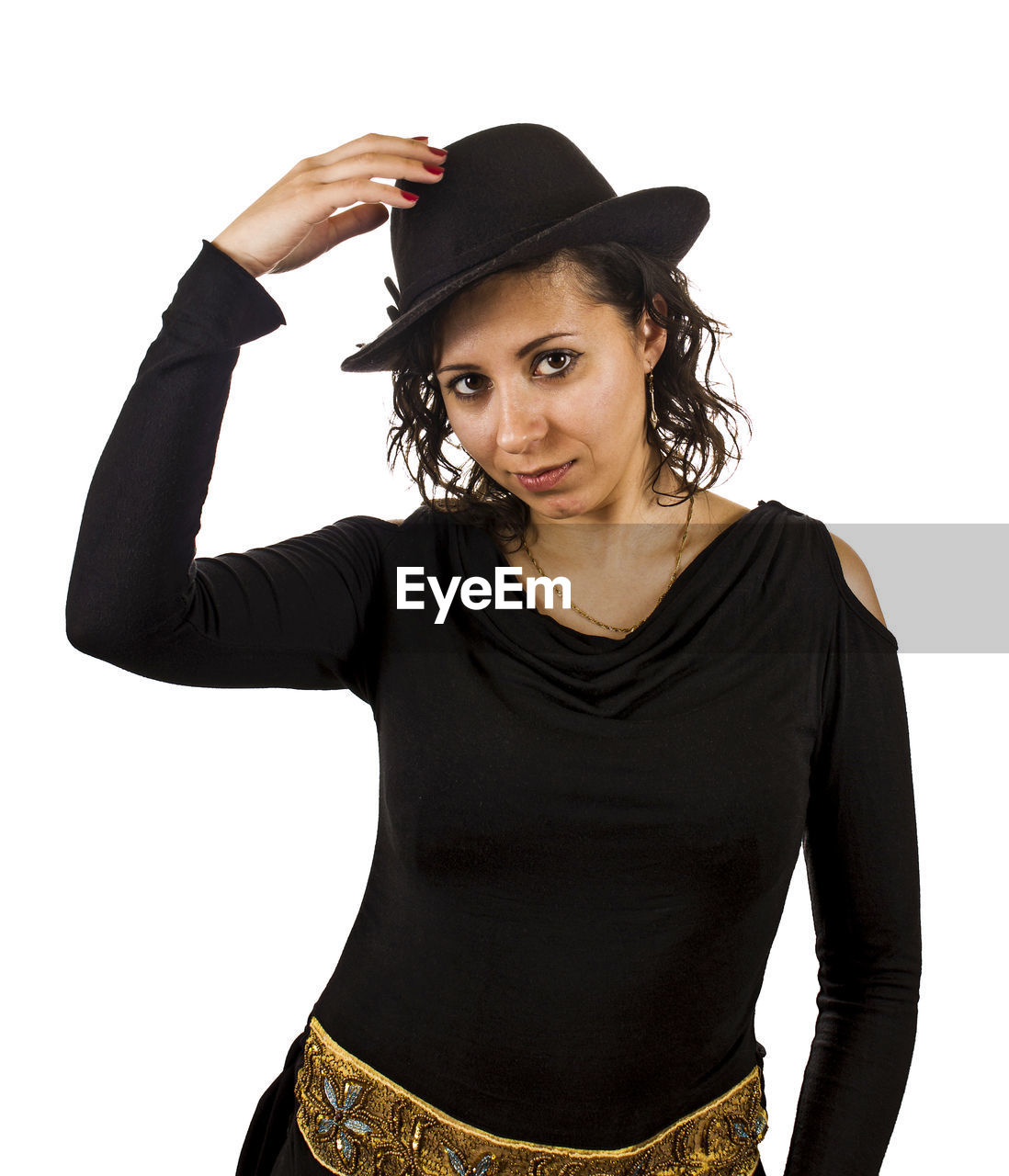 Portrait of woman wearing hat while standing against white background