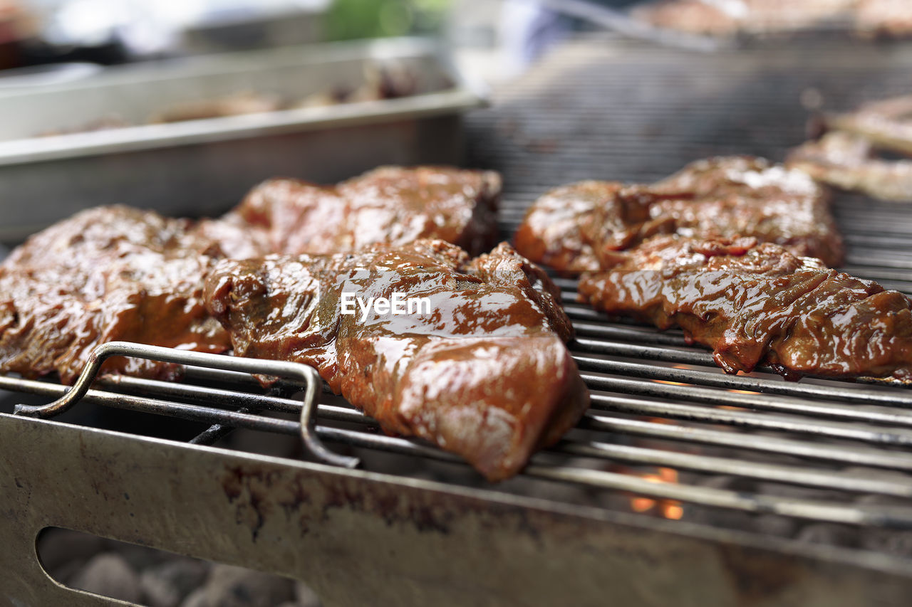 Meat being grilled on a barbecue in a belgian restaurant. daytime shot with natural light 