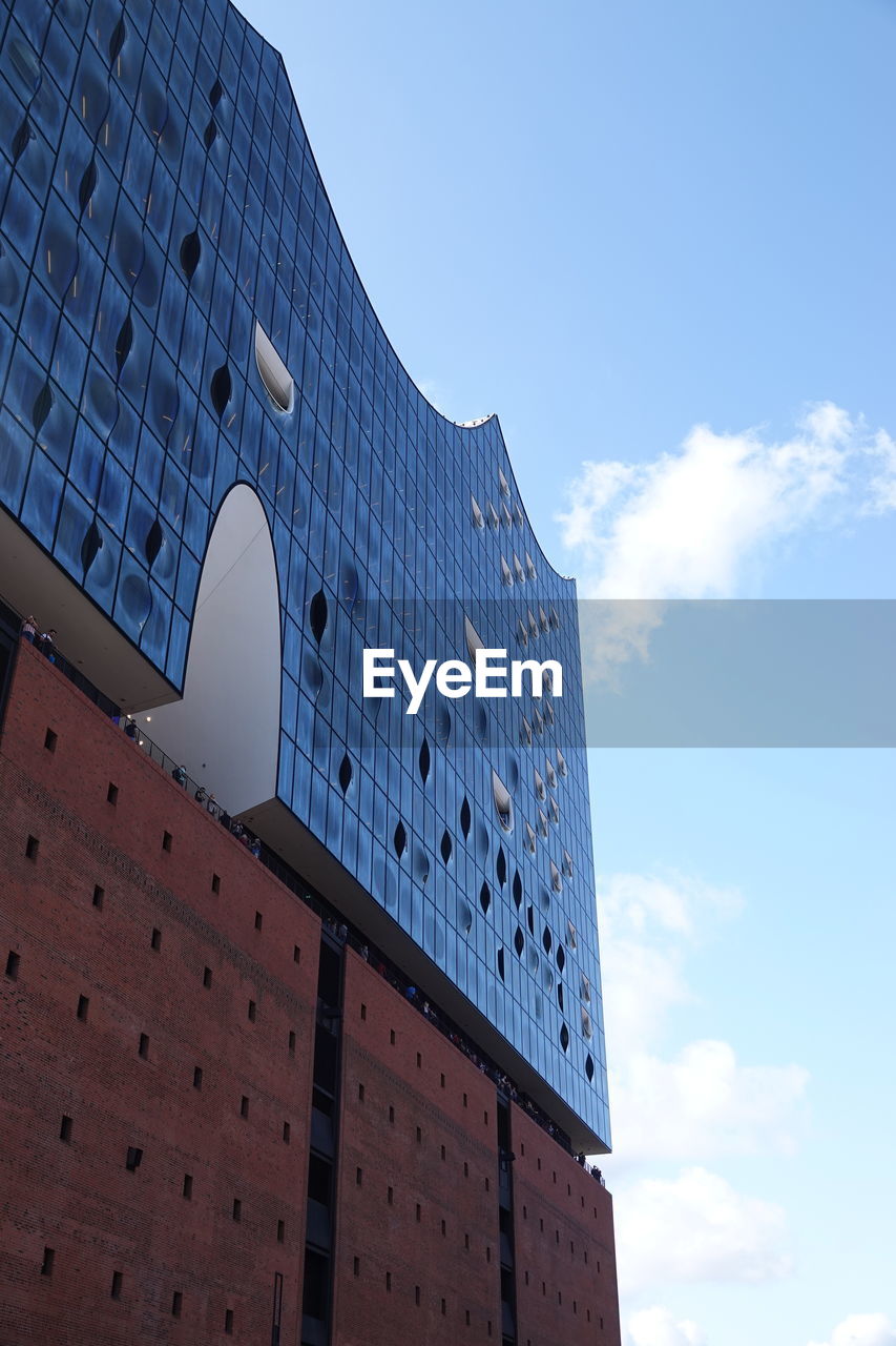 Low angle view of building against cloudy sky