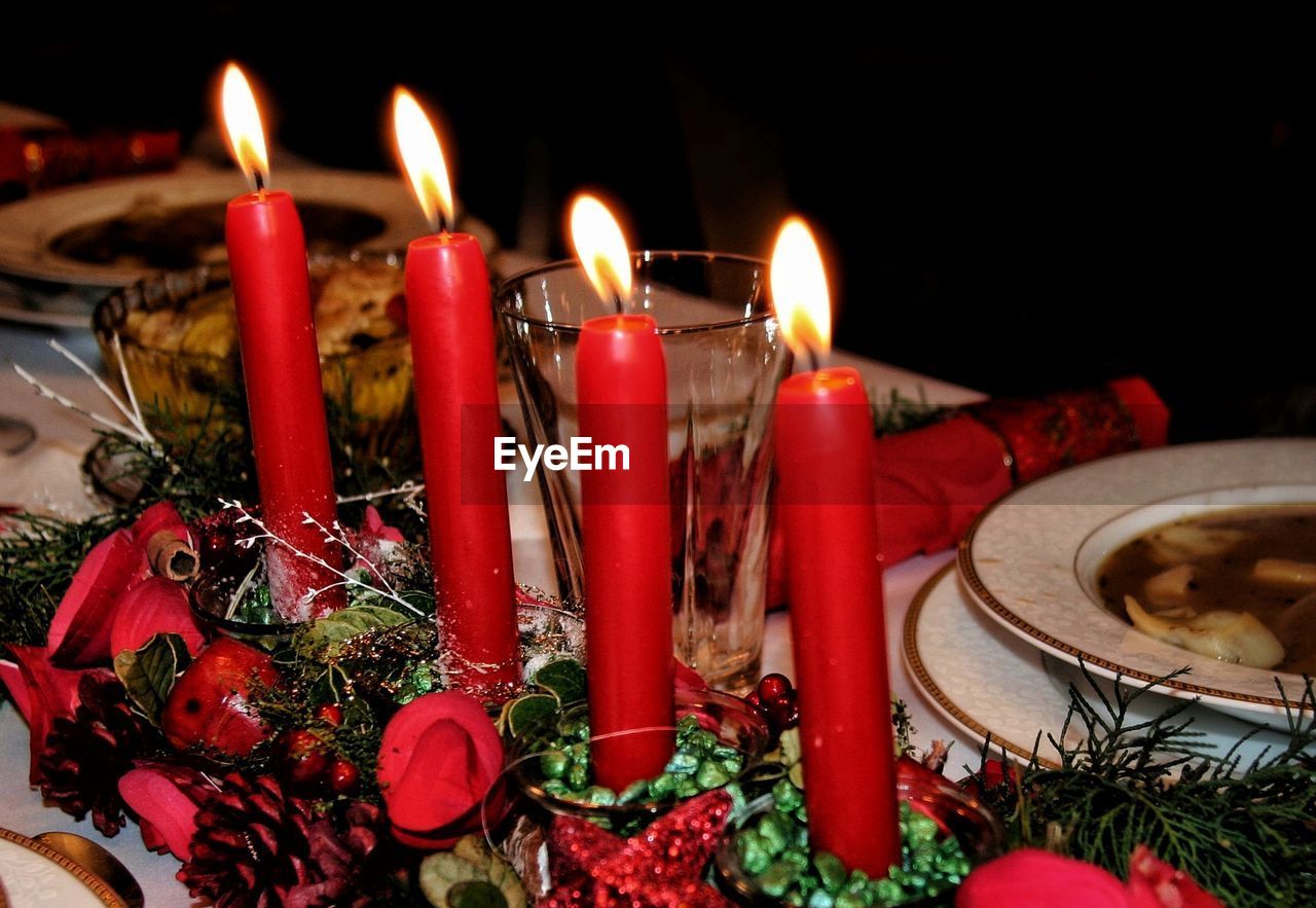 Close-up of illuminated candles on table