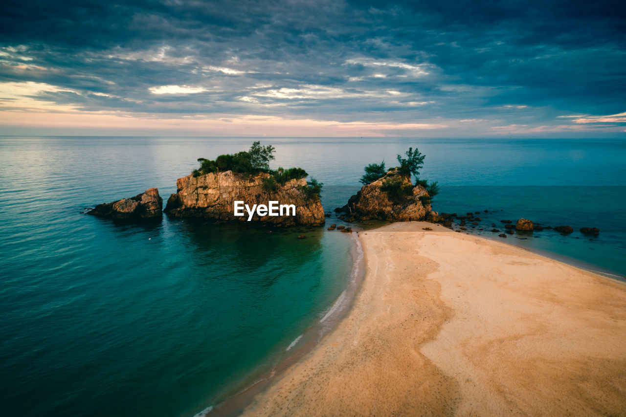 Scenic view of beach with huge sea stacks at sunrise