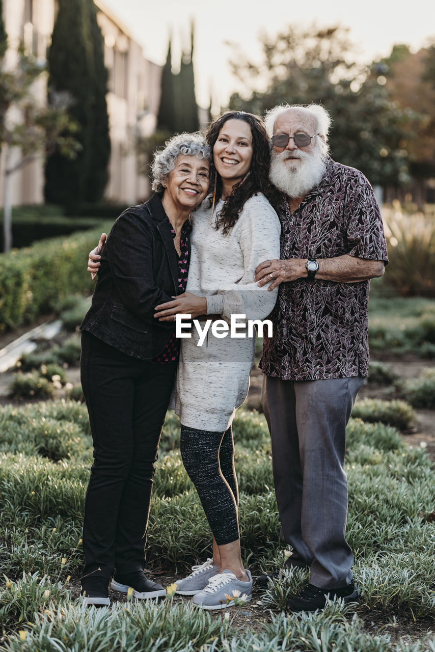 Portrait of active senior married couple and adult daughter smiling
