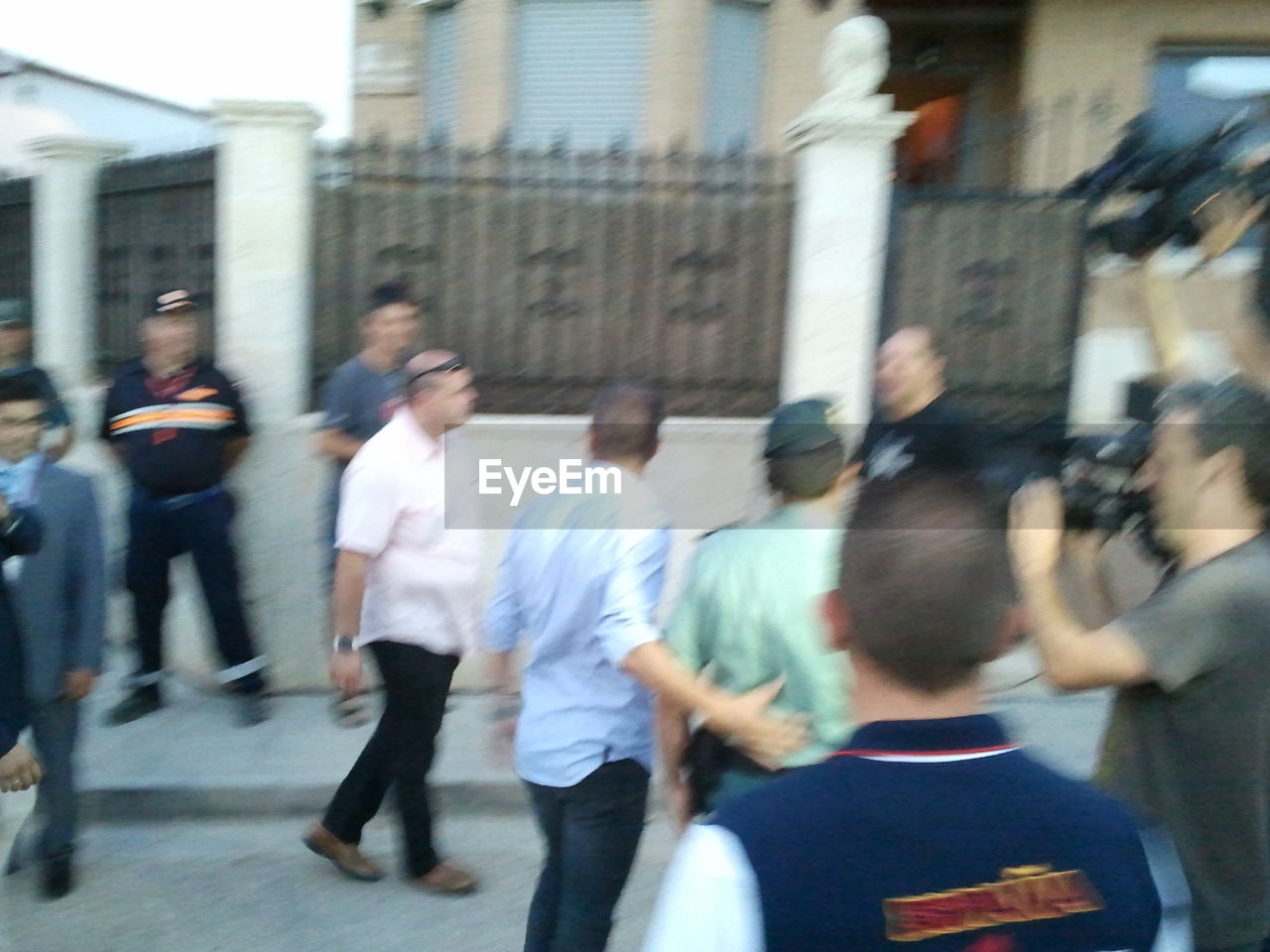 BLURRED MOTION OF PEOPLE WALKING ON ROAD IN CITY