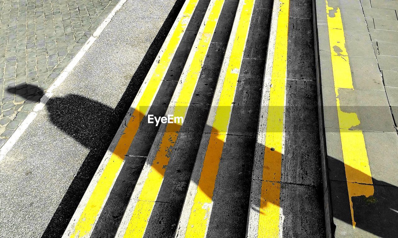 High angle view of yellow crossing markings on road