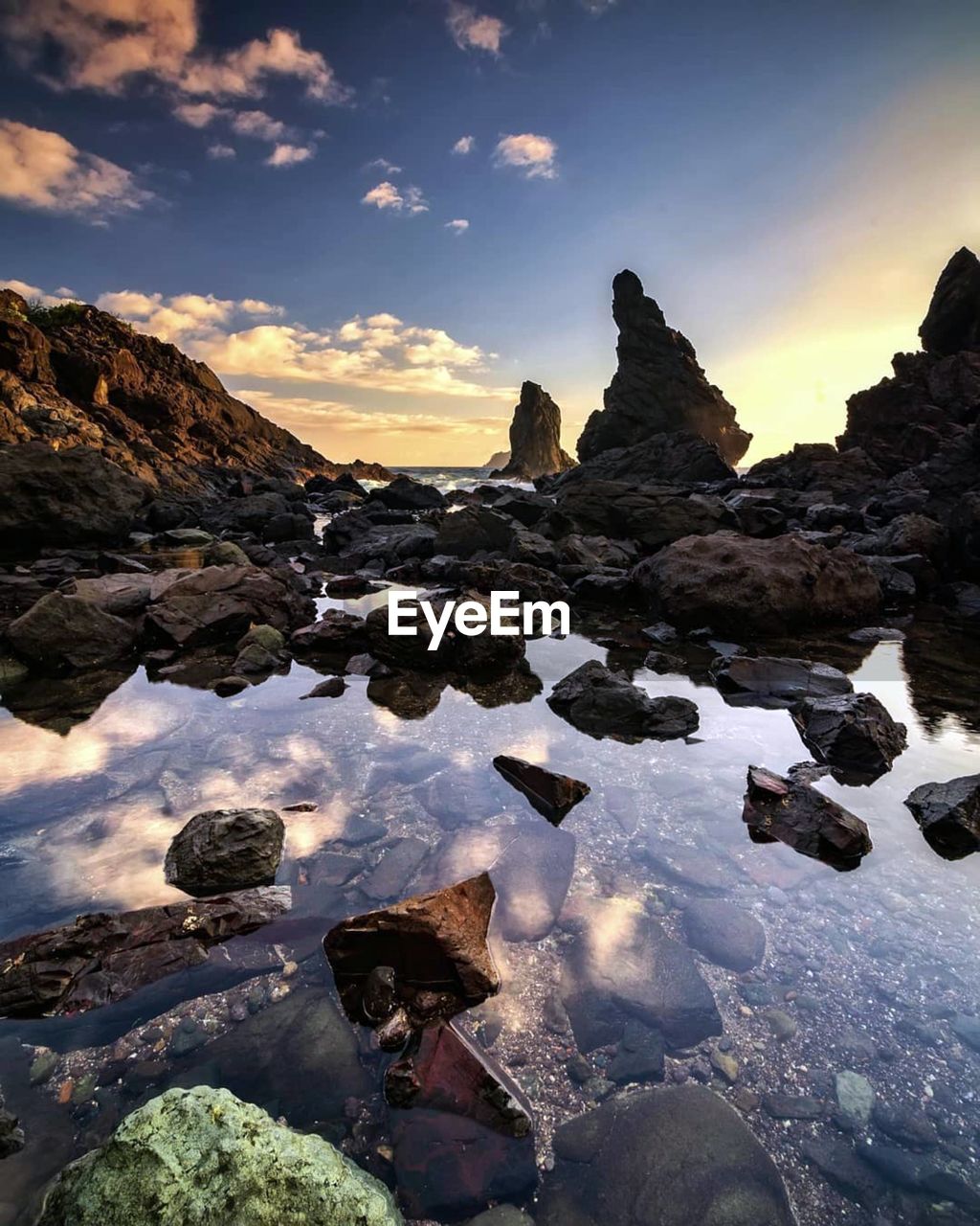 ROCKS IN WINTER AGAINST SKY