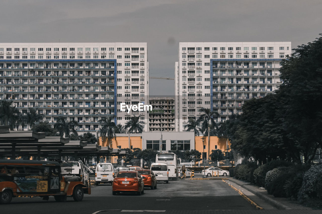 Cars on road by buildings in city