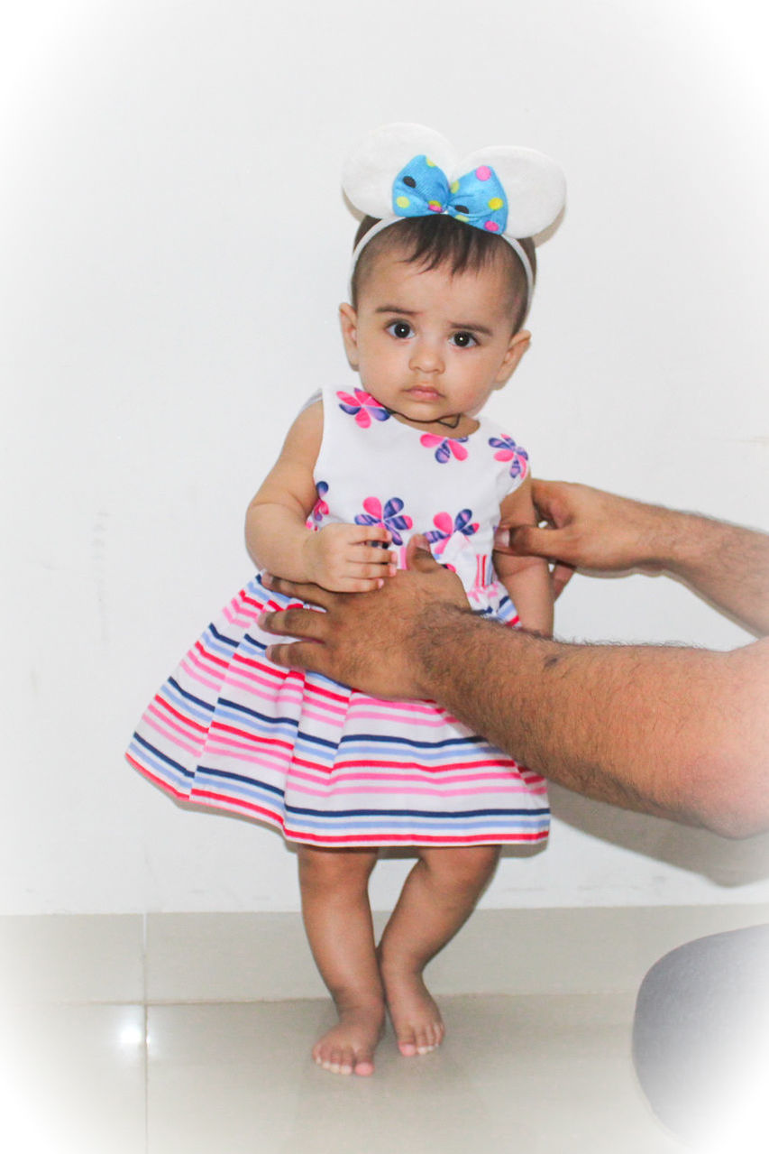 FULL LENGTH OF CUTE GIRL WITH ARMS RAISED