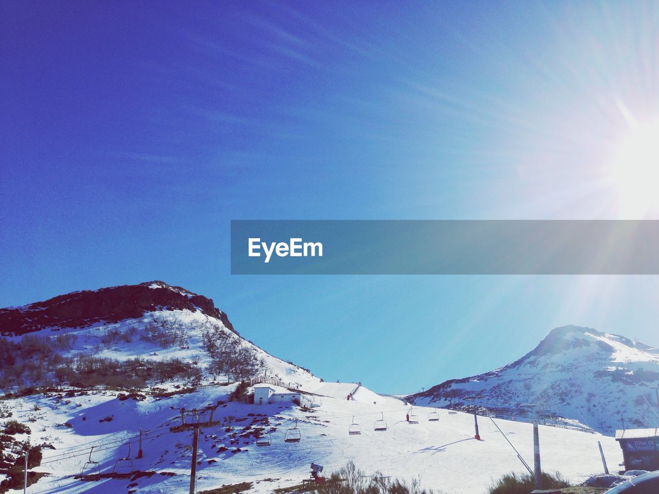 Ski lifts on snow covered landscape