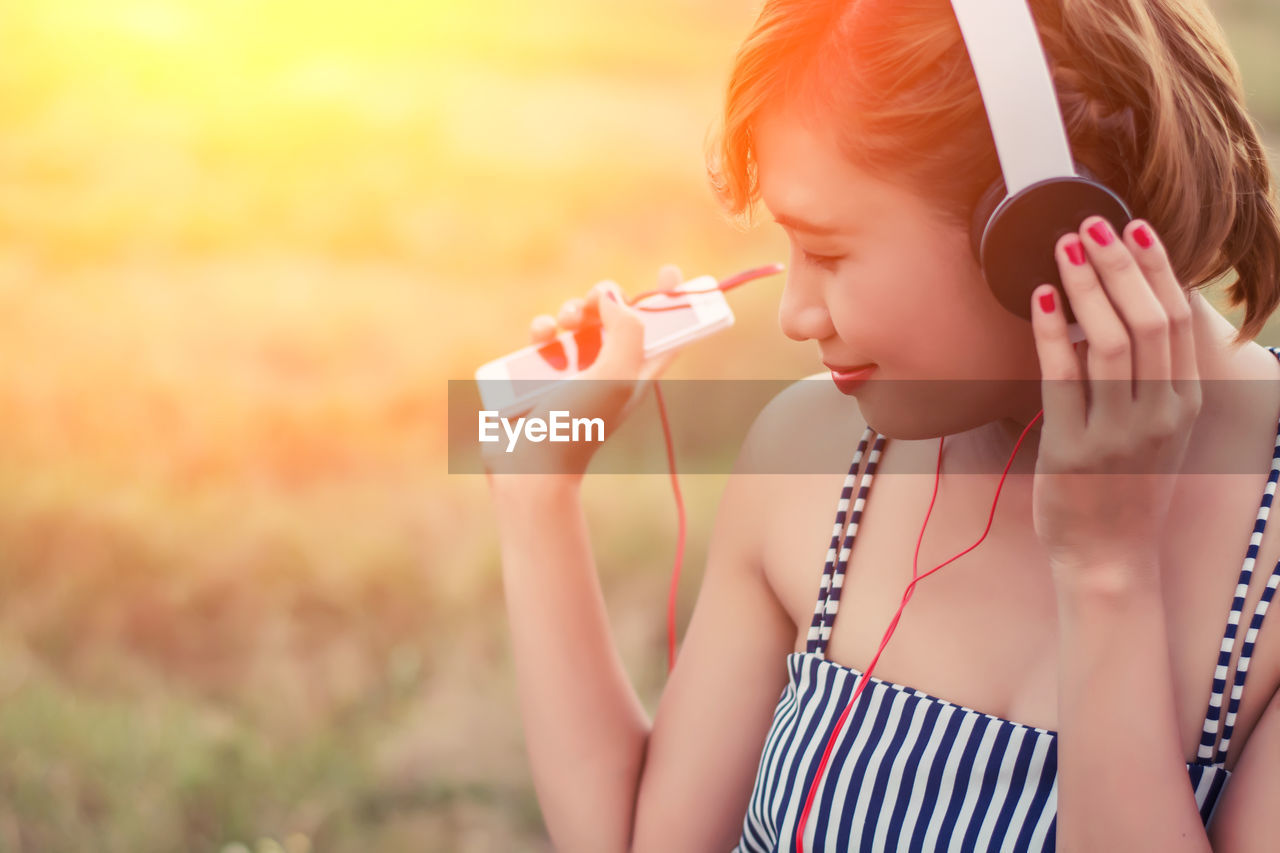 Close-up of woman listening music