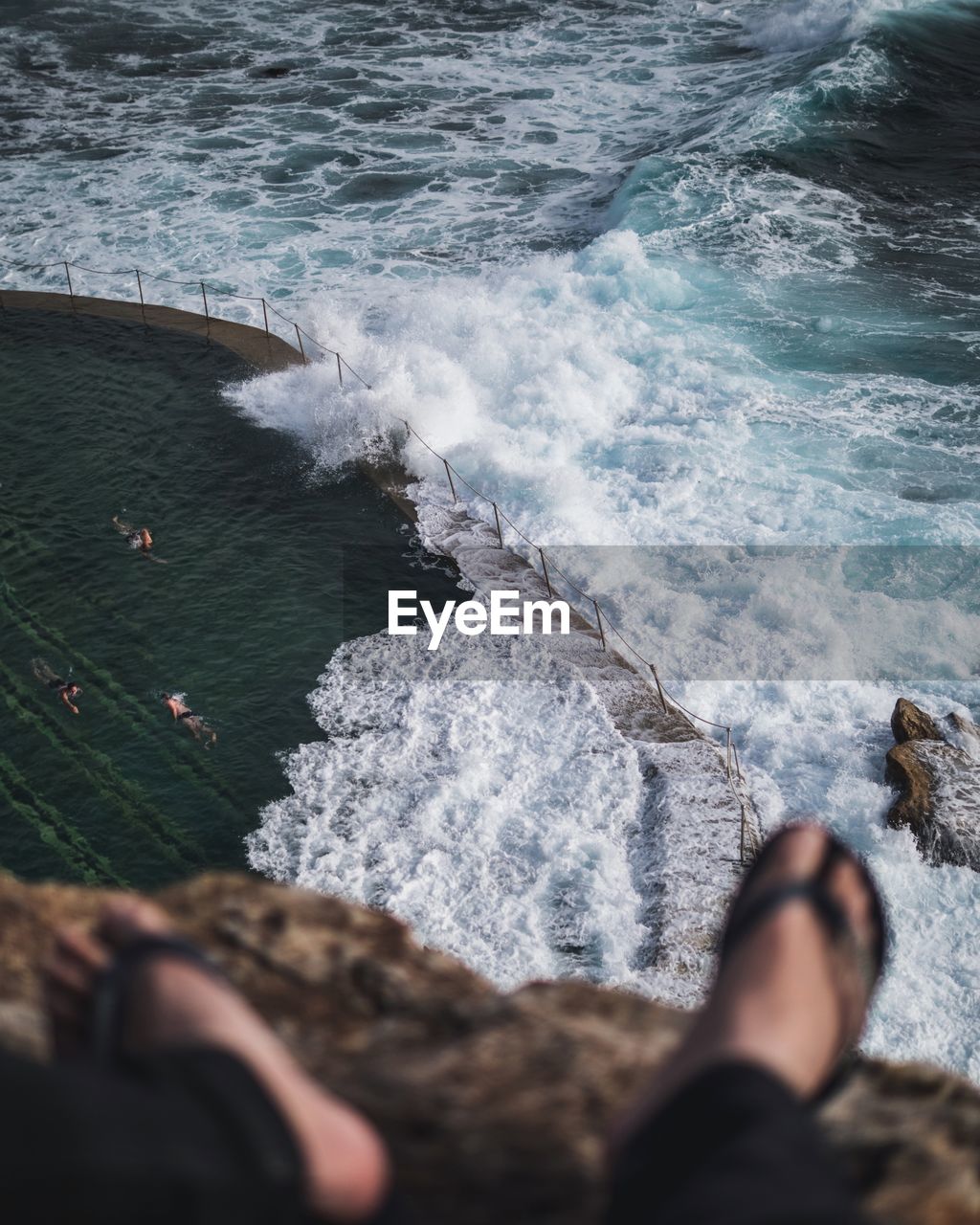 High angle view of waves rushing towards infinity pool