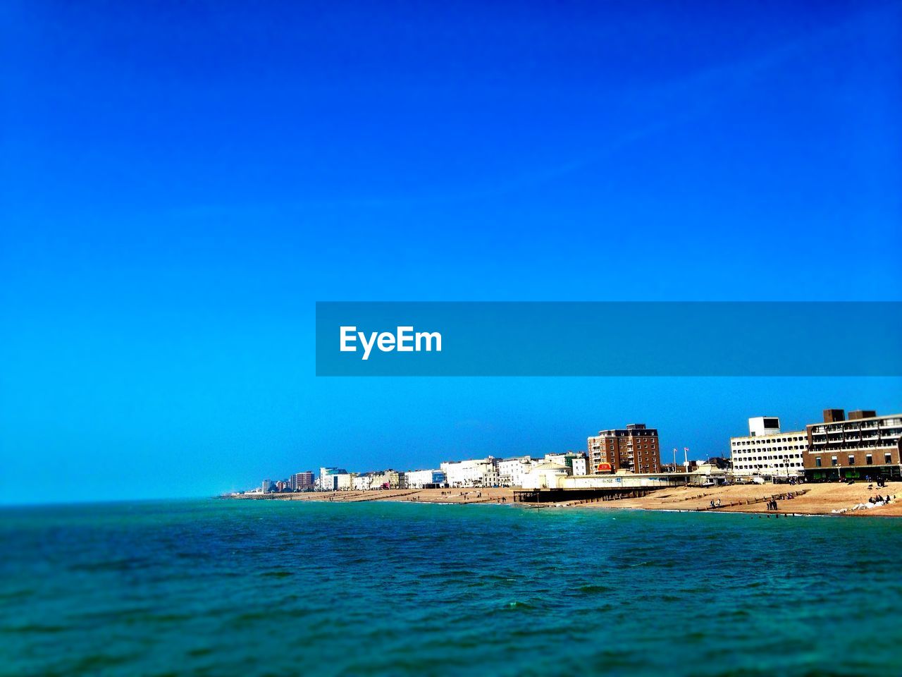 SURFACE LEVEL OF CALM BLUE SEA AGAINST CLEAR SKY