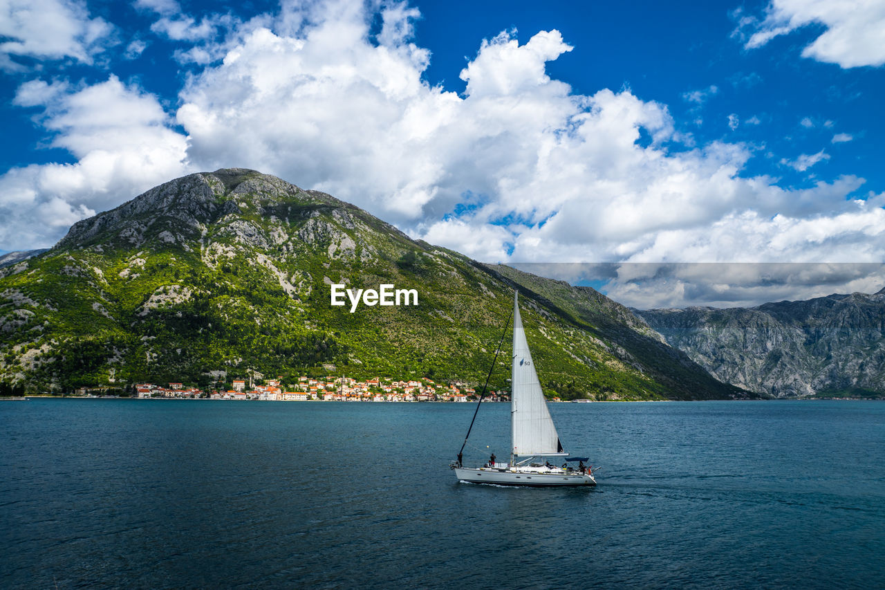 Sailboat in sea against sky