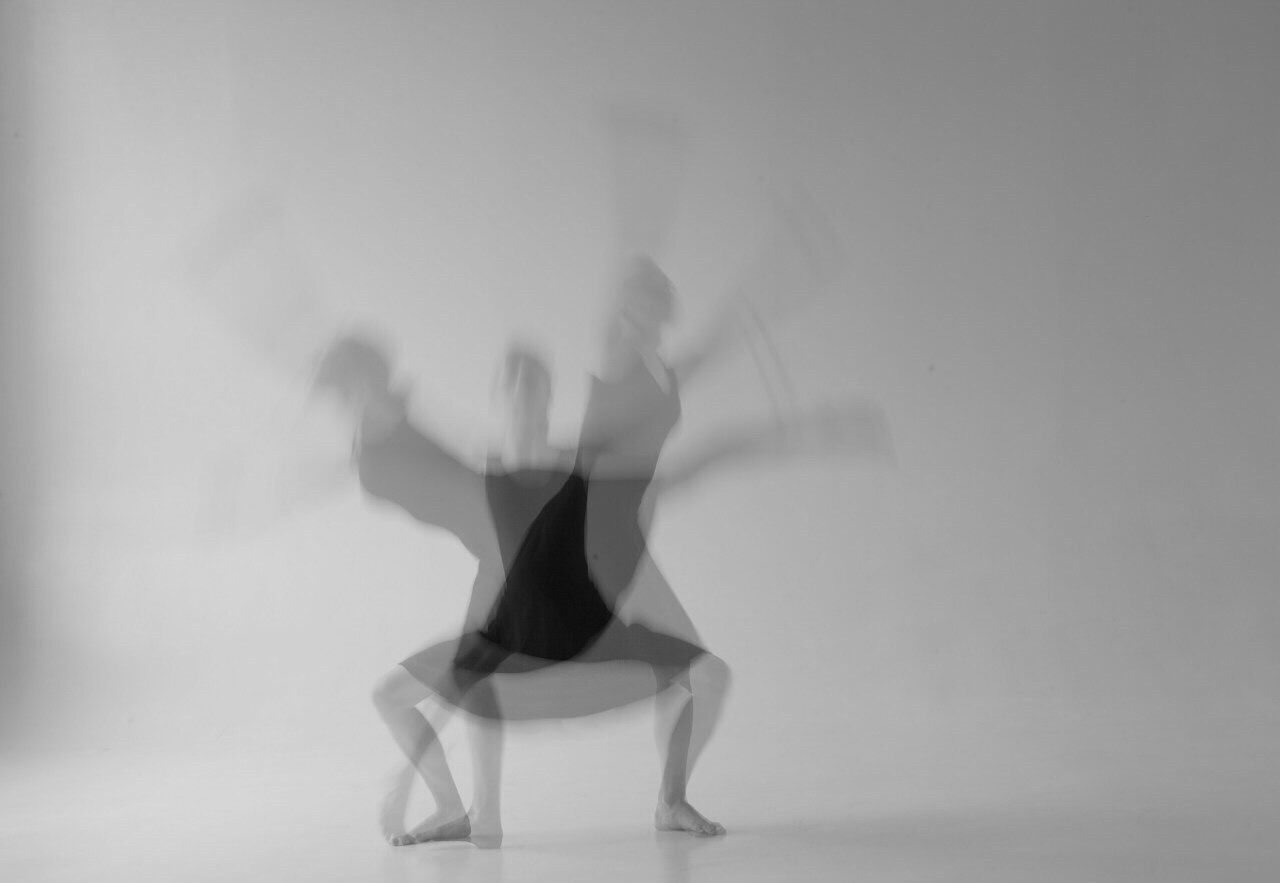 Multiple image of woman dancing against gray background