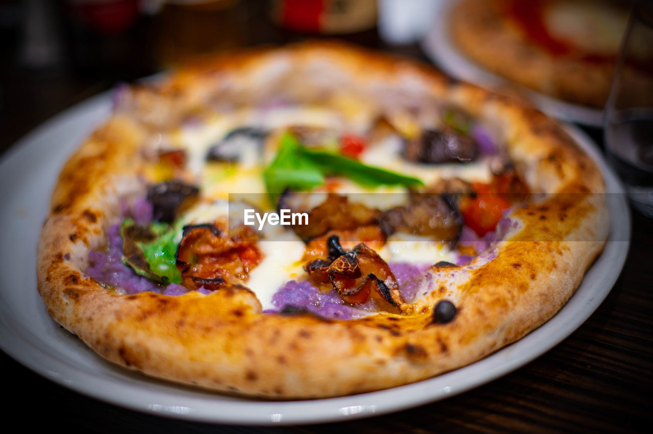 food and drink, food, pizza, fast food, cheese, vegetable, dairy, dish, cuisine, italian food, unhealthy eating, freshness, restaurant, no people, fast food restaurant, olive, close-up, fruit, meal, meat, business, indoors, herb, sausage, table, mushroom, baked