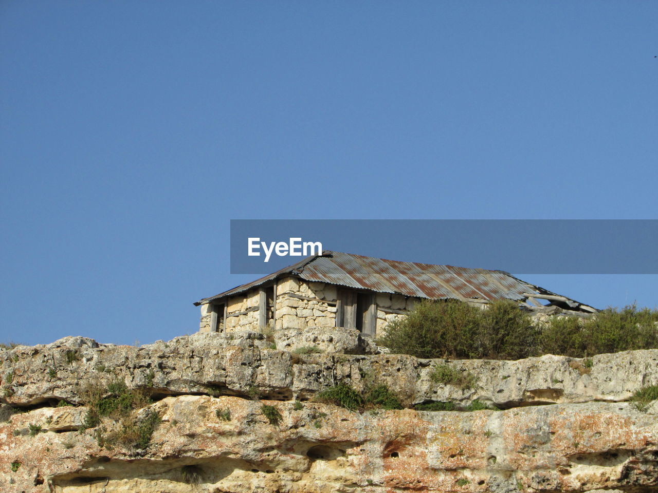 Low angle view of house against clear blue sky