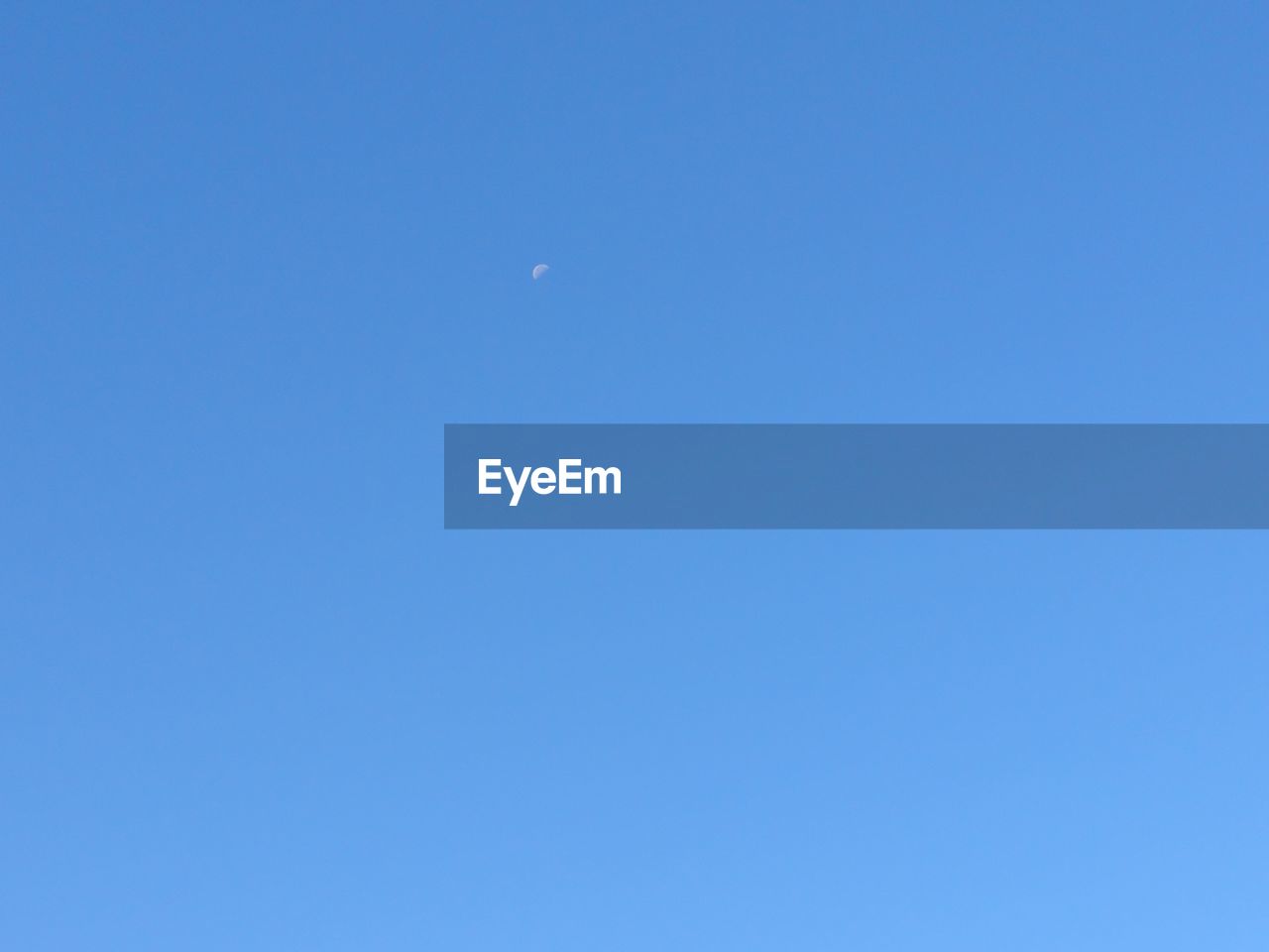 LOW ANGLE VIEW OF MOON IN SKY