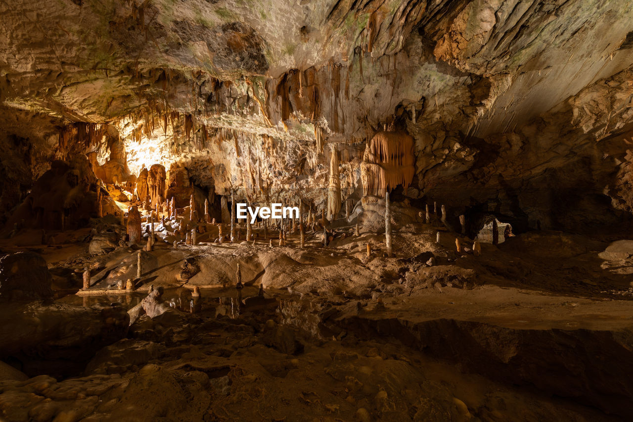 ROCK FORMATIONS IN CAVE AT NIGHT