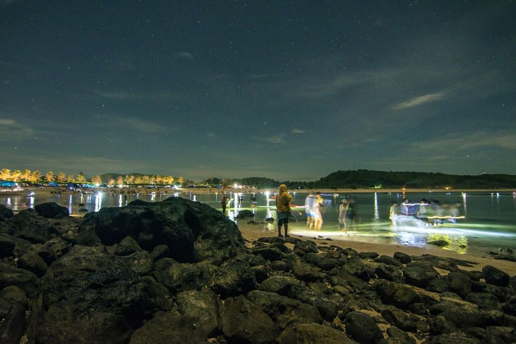 VIEW OF ILLUMINATED ROCKS AT NIGHT