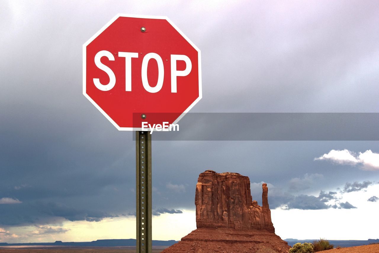 Road sign against sky