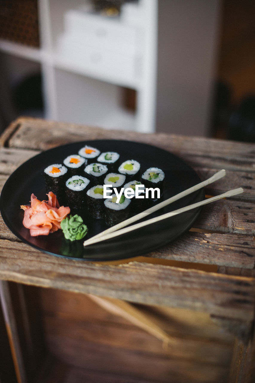Sushi served on black plate