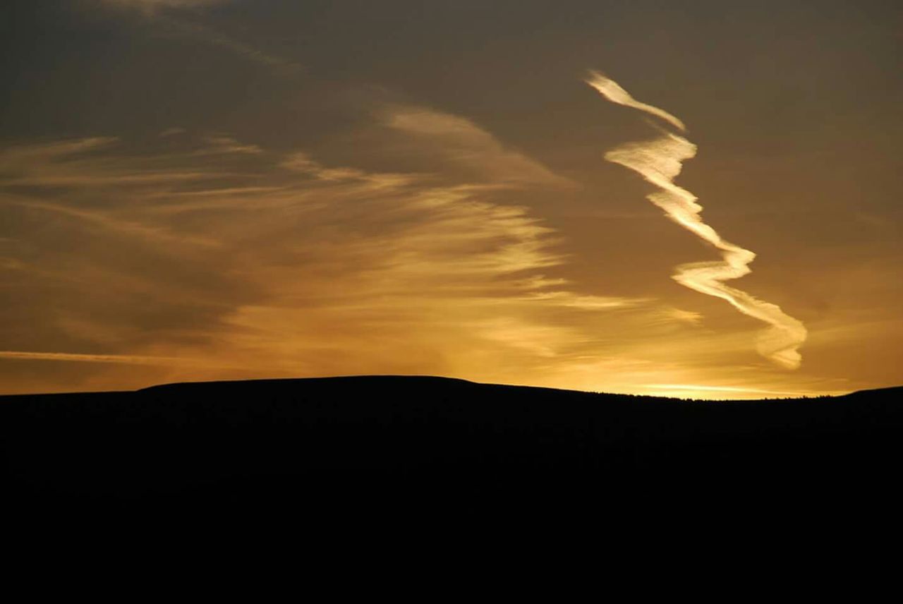 Silhouette of hill at sunset