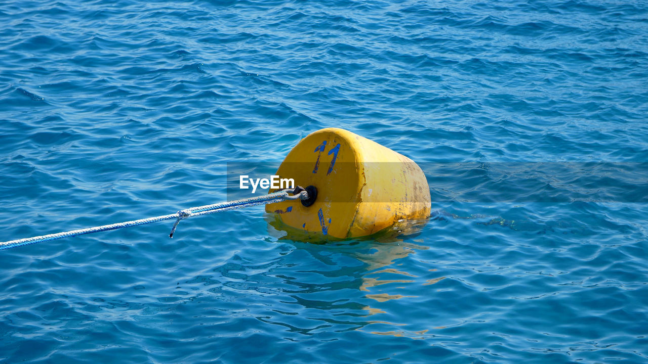 water, buoy, sea, nature, day, yellow, blue, high angle view, nautical vessel, rippled, outdoors, no people, floating on water, waterfront, floating, rope, vehicle, boating, transportation, protection, ocean, security