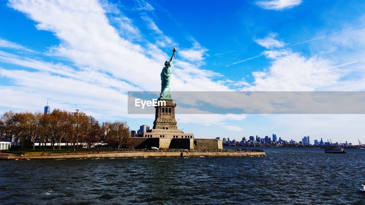 Statue of liberty with city in background