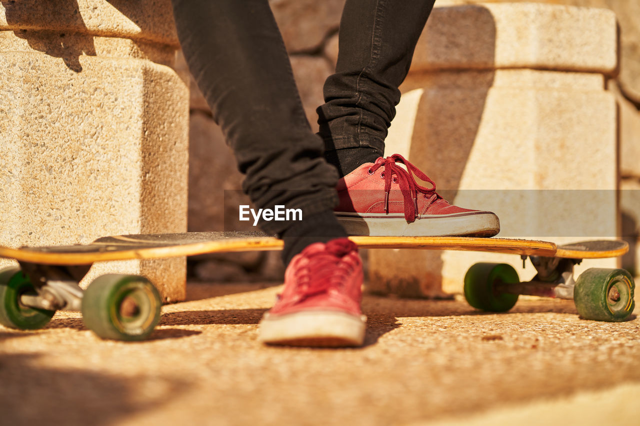 Low section of man skateboarding on skateboard