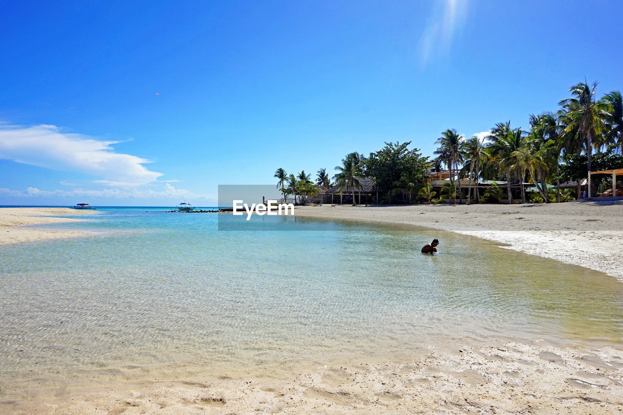 Scenic view of sea against blue sky