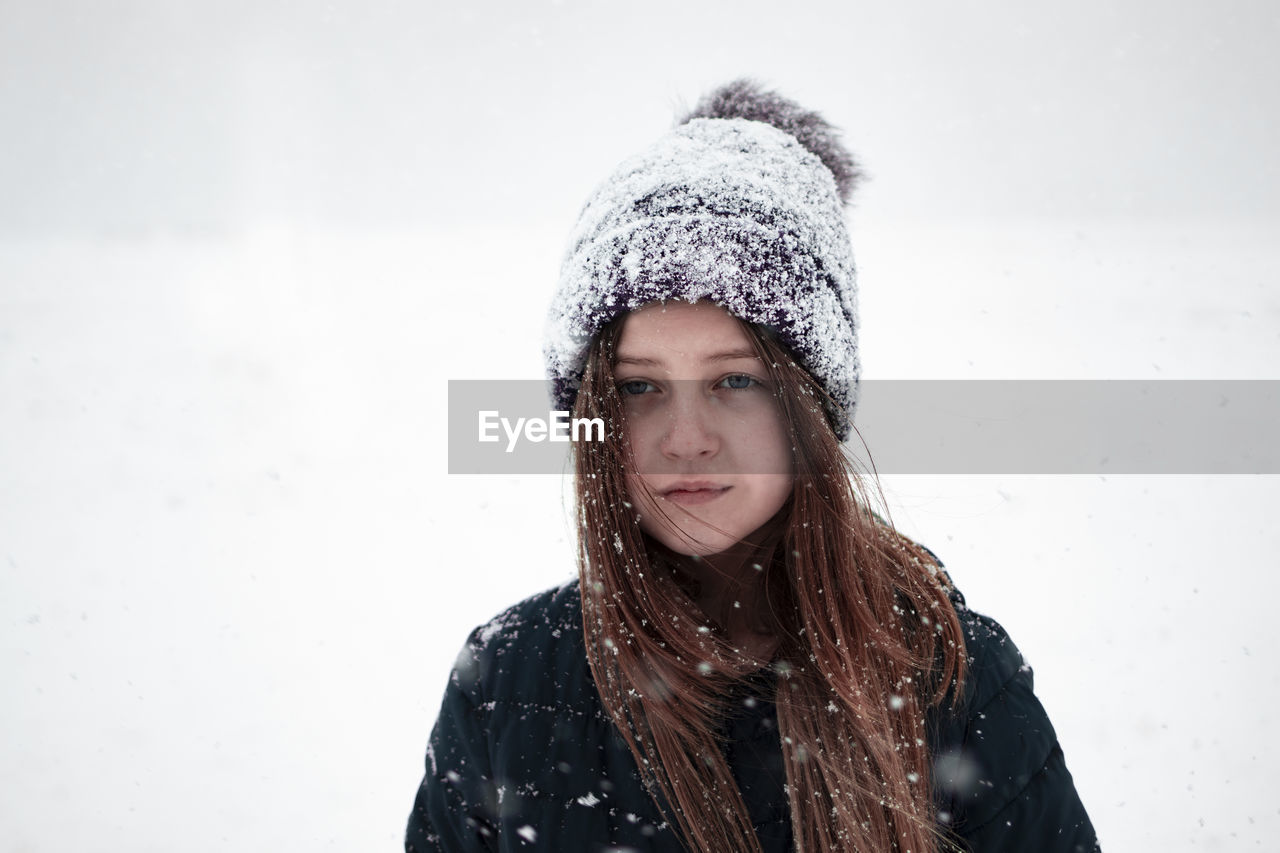 Portrait of beautiful young woman in snow