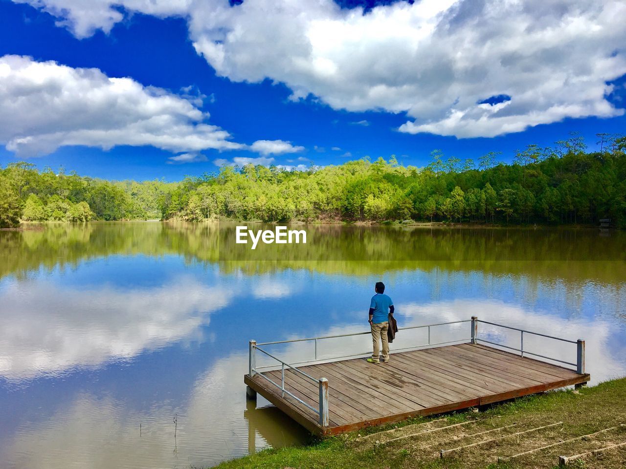 Rear view of man standing on pier