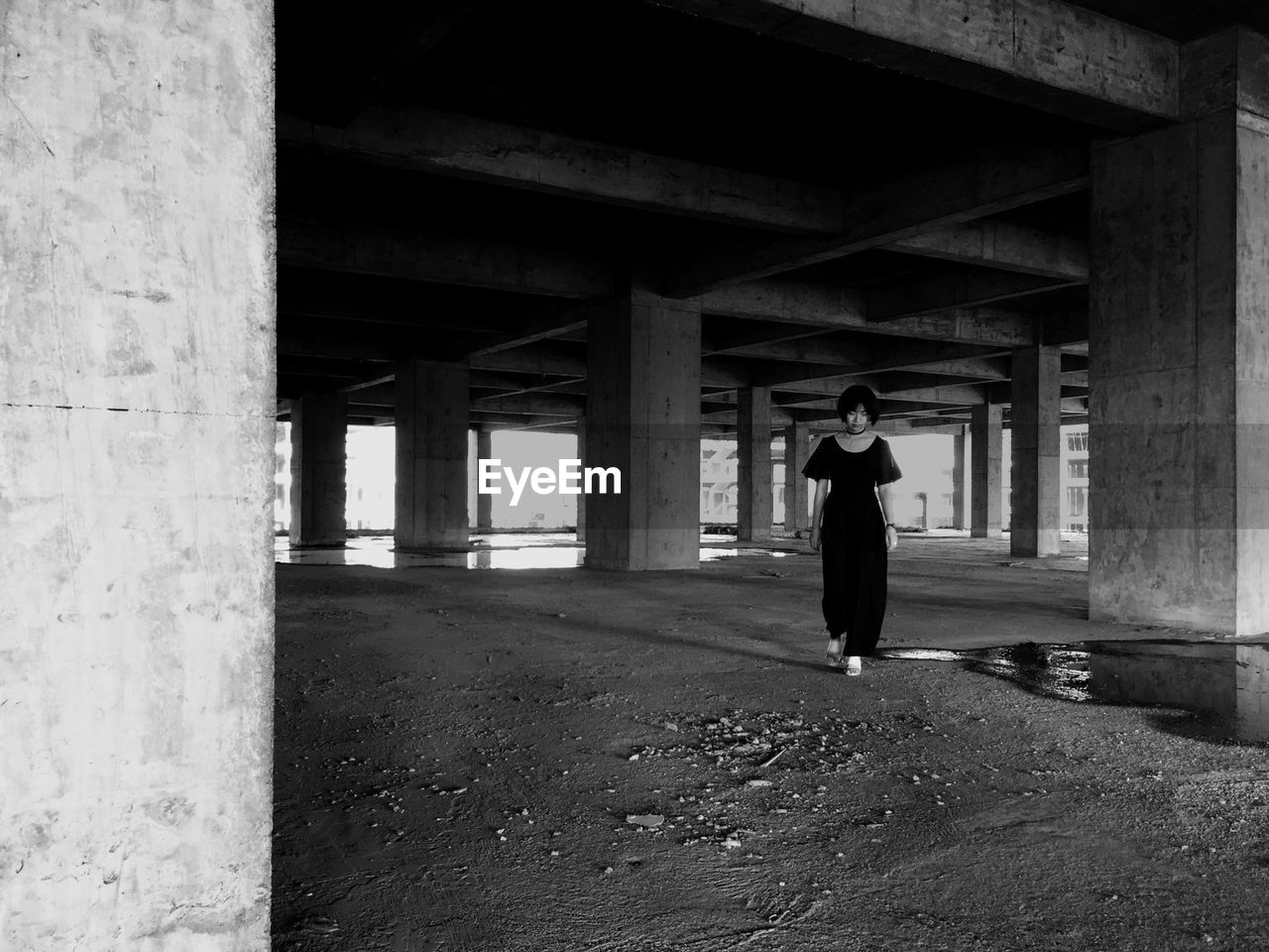 Full length of woman walking under bridge