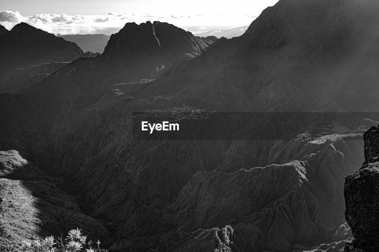 mountain, environment, landscape, scenics - nature, black and white, beauty in nature, nature, mountain range, monochrome photography, monochrome, land, sky, rock, travel, travel destinations, non-urban scene, no people, tranquility, cloud, outdoors, darkness, tourism, tranquil scene, terrain, extreme terrain, geology, valley, mountain peak, physical geography, day, activity, rock formation