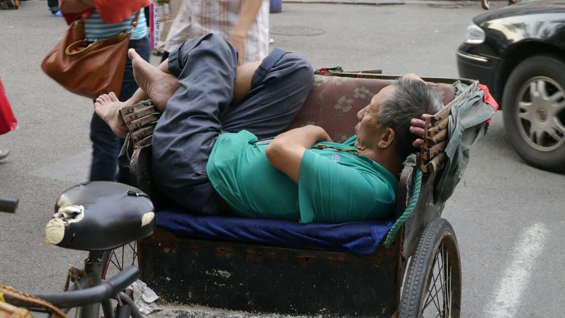 PEOPLE SITTING ON RAILROAD TRACK