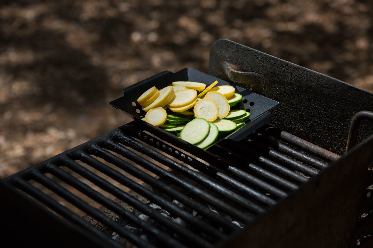 High angle view of sliced vegetables in barbeque grill at park