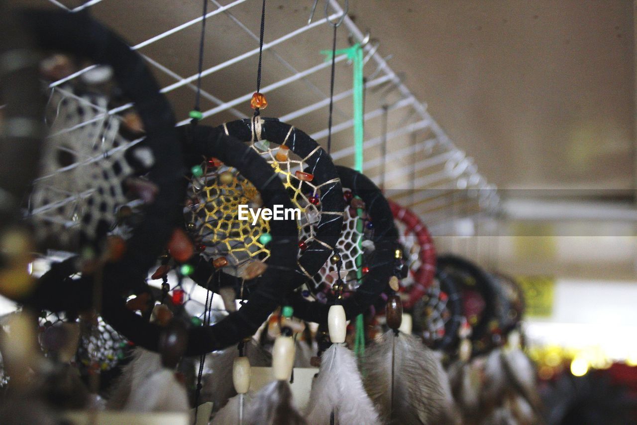 Close-up of dream catchers hanging at market stall