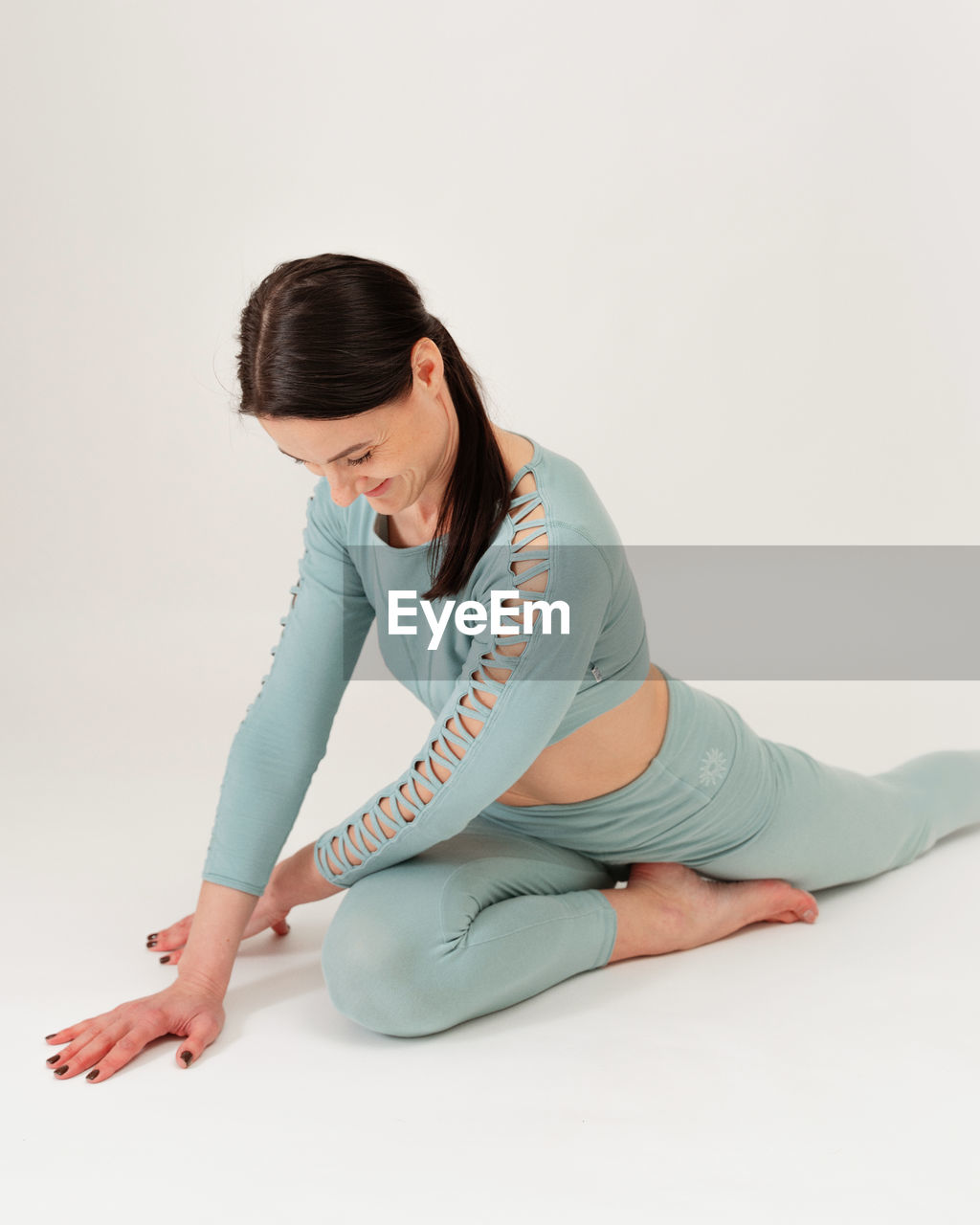 side view of young woman suffering from pain against white background