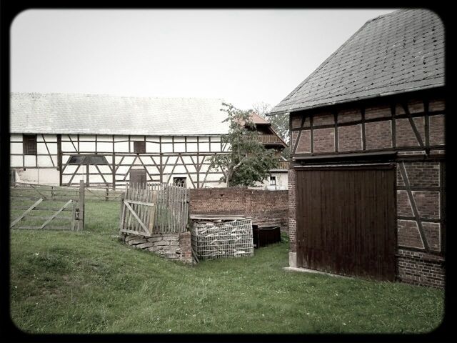 WOODEN STRUCTURE ON GRASSY FIELD