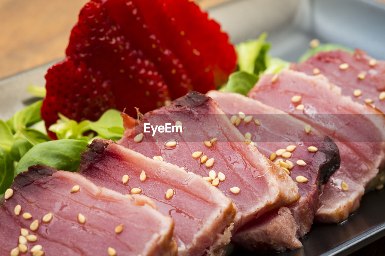 Close-up of tuna tataki garnished with sesame seeds