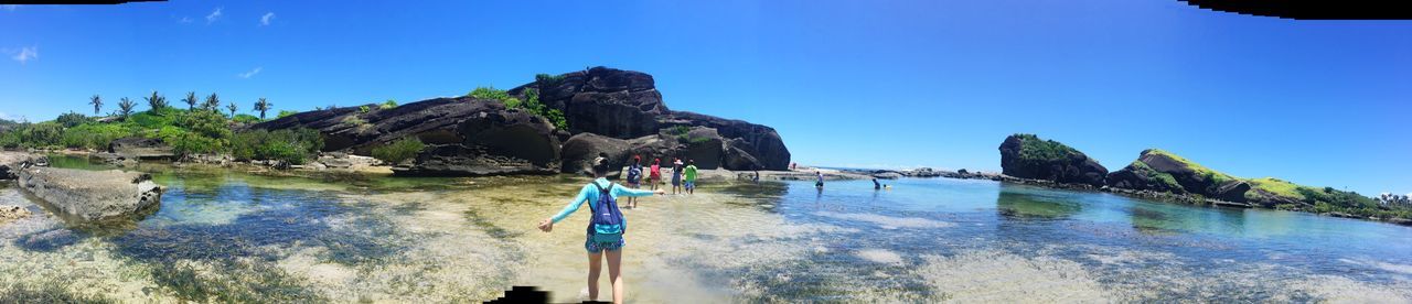 PANORAMIC VIEW OF SEA AND ROCK FORMATION AGAINST CLEAR BLUE SKY