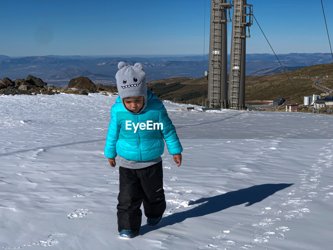 Little boy in the snow of the mountains of sierra nevada